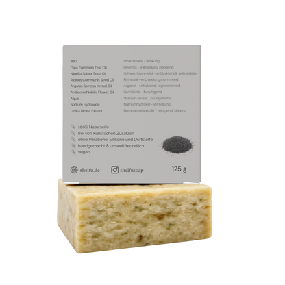 Zutatenliste und Wirkung der Schwarzkümmel Naturseife auf grauer umweltfreundlicher Rückseite